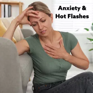 Woman with hand to chest and head, feeling unwell.