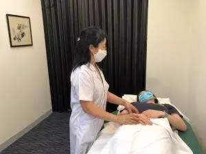 Dr. Cai treating a patient