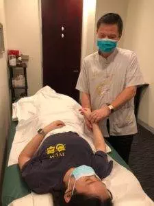 Dr. Tan treating a patient